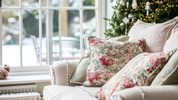 Colorful pillows on sofa against glass wall of window in a winter garden or conservatory. Interior textile concept. High quality photo