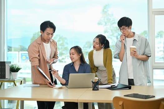 Modern business startup team brainstorming ideas during a work session in co working space.