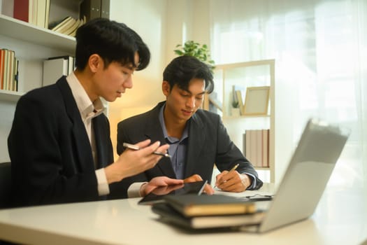Professional advisor and client reviewing and discussing contract terms in a bright office.