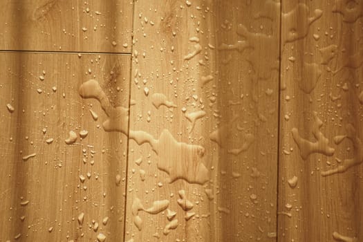 A closeup image shows water droplets on a wooden surface, creating a refreshing ambiance