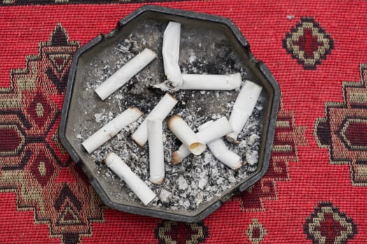 Close up burning cigarette in ashtray ,