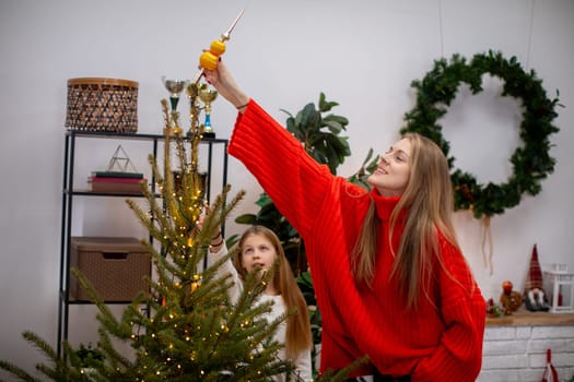 A joyful family decorates a beautiful Christmas tree, capturing the holiday spirit and togetherness