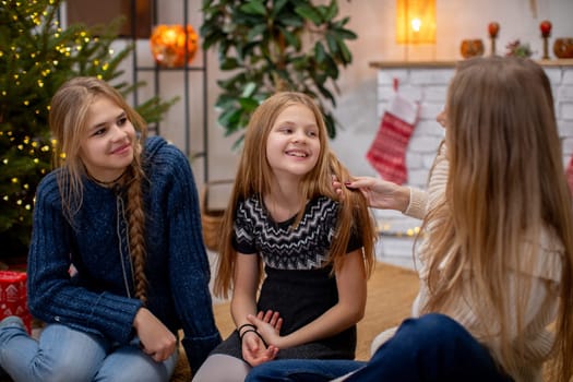 A joyful family moment by the beautifully decorated Christmas tree, sharing smiles and love together as one