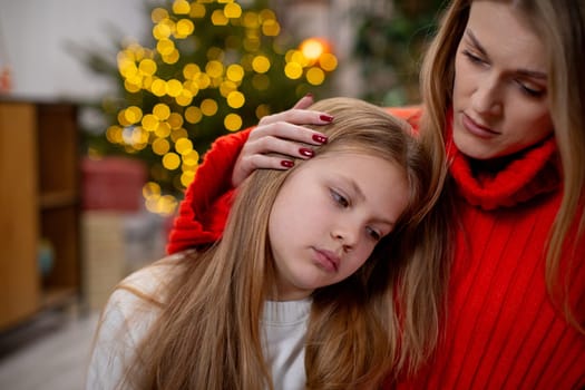 A mother brings deep comfort to her daughter during the festive season, capturing a heartfelt moment