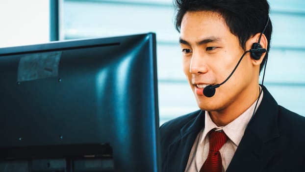 Business people wearing headset working in office to support remote customer or colleague. Call center, telemarketing, customer support agent provide service on telephone video conference call. Jivy