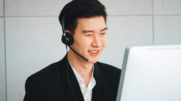 Business people wearing headset working in office to support remote customer or colleague. Call center, telemarketing, customer support agent provide service on telephone video conference call. Jivy