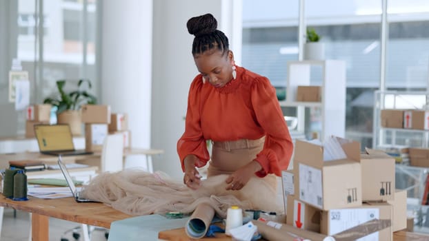 Fashion logistics, designer and black woman with box for clothing brand, texture and pattern in workshop. Retail, boutique and person with material for creative startup, small business and store.