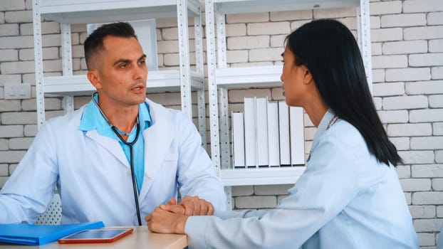 Doctor in professional uniform examining patient at hospital or medical clinic. Health care , medical and doctor staff service concept. Jivy