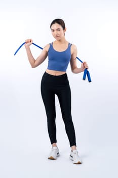 Young energetic asian woman in sportswear with jumping or skipping robe posing portrait in studio shot on isolated background. Cardio exercise tool and healthy body care lifestyle. Vigorous