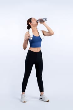 Athletic and sporty asian woman resting and drink water after intensive cardio workout training. Healthy exercising and fit body care lifestyle pursuit in studio shot isolated background. Vigorous