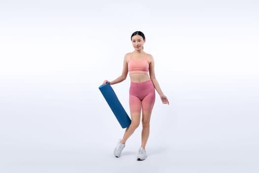 Young attractive asian woman portrait in sportswear with exercising mat. Healthy exercise and workout routine lifestyle concept. Studio shot isolated background. Vigorous