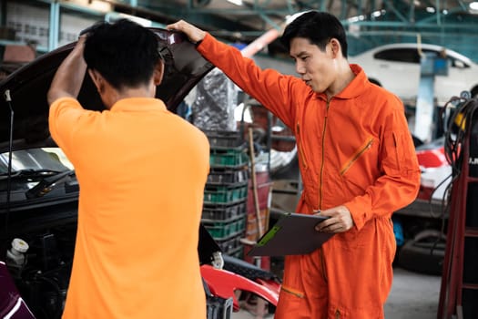 Automotive service mechanic inspect and diagnose car engine issue, repairing and fixing problem in garage workshop. Technician car care maintenance working on internal components of vehicle. Oxus