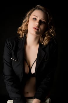 Pretty blonde in unbuttoned jacket and black linegrie cropped shot