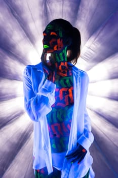 Girl in white shirt and pants with beautiful UV bodyart cropped view