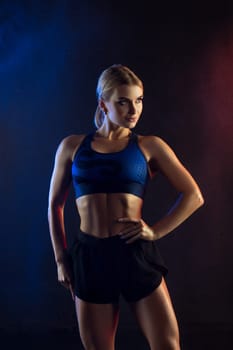 Athletic beautiful blonde cropped shot against wall
