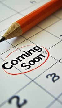 Close-up of a calendar page featuring a date circled in red with coming soon in bold letters next to it. emphasizes anticipation and planning, ideal for event announcements or reminders, and suitable for print or digital use.