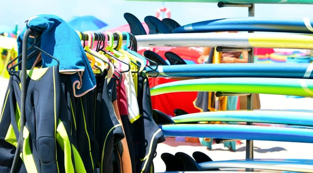 Surfboards and uniforms on the beach of Atlantic ocean at the surf school