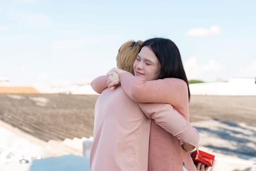 A couple shares a heartfelt embrace on Valentine celebrating love with a sweet surprise.