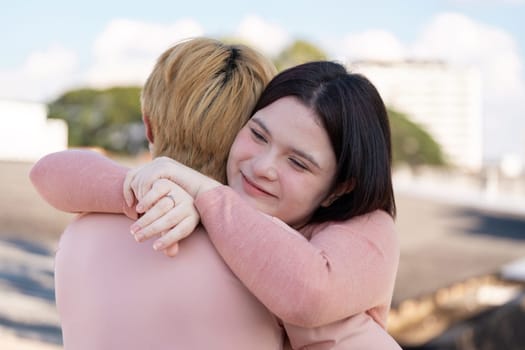 A couple shares a warm embrace celebrating love and connection on Valentine Day in a beautiful outdoor setting.