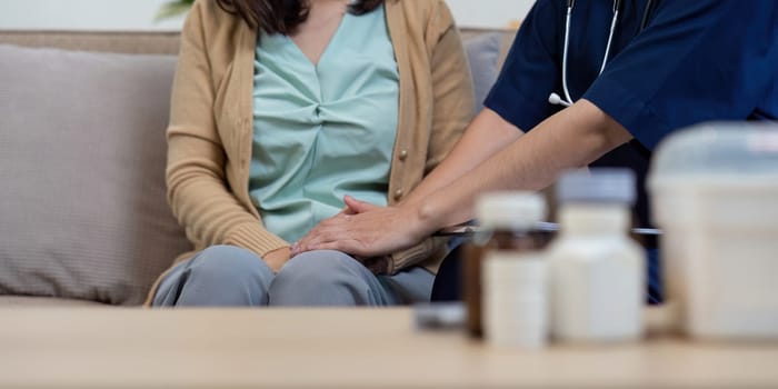 A caregiver provides support to an elderly patient during a doctor visit highlighting the importance of compassionate healthcare.