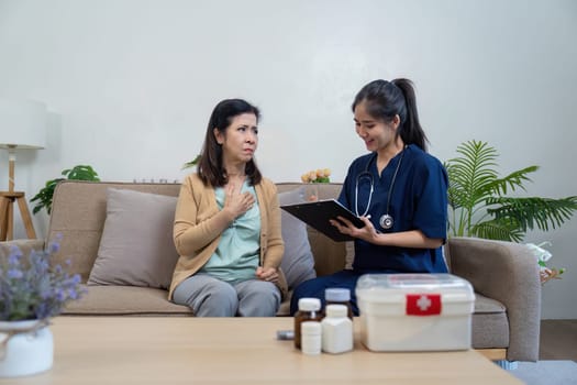 A caregiver provides a health assessment for an elderly patient in a cozy home setting ensuring compassionate support.