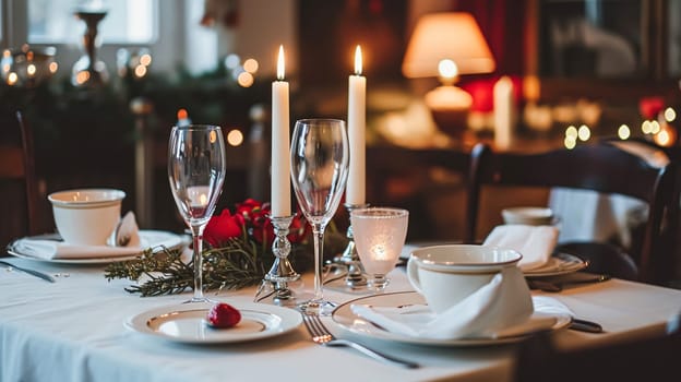 Festive table setting with candles and arrangement of beautiful red flowers. Holiday concept. High quality photo