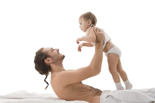 Happy father holding his son in his arms sitting in bed isolated profile shot