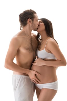 Handsome shirtless male with closed eyes kissing and touching beautiful pretty female against white background