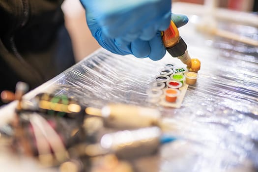 Tattoo colors lying on the table in a tattoo salon shot