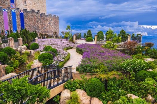 fabulous royal garden, bushes and flowers in the back, manicured trees and shrubs