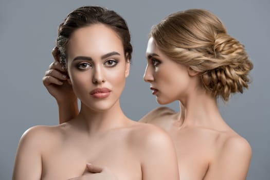 Two gorgeous women with fine makeup and hairstyles topless portrait