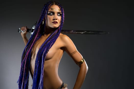 Amazon topless with blue braids with a sword portrait