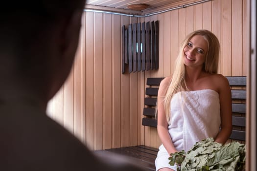Young beautiful couple relaxing in sauna shot