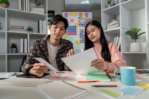 A team collaborates on graphic design projects fostering creativity and innovation in a modern office environment.