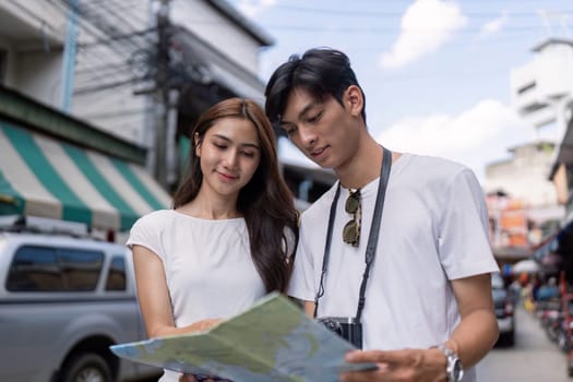 A couple navigates a vibrant urban market sharing a travel experience filled with discovery and joy.