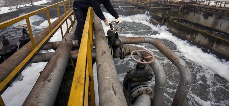 Operators monitor and adjust valves at a historic water treatment facility, ensuring proper water processing and flow management.