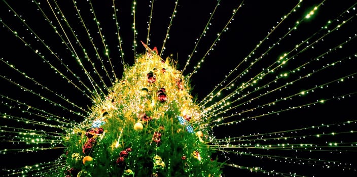 A beautifully decorated Christmas tree covered in colorful ornaments and bright lights radiates joy and warmth during the holiday season.