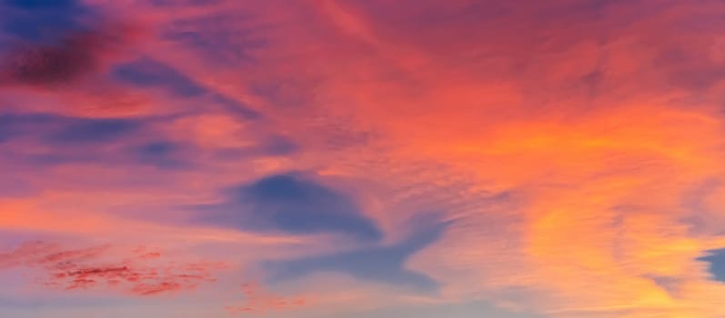 red orange clouds at sunset in a beautiful sky in the evening
