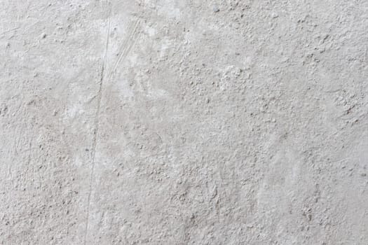 A textured white concrete surface featuring rough details and natural imperfections, suitable for minimalist and industrial-themed projects.