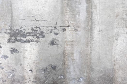 A rough-textured concrete surface showcasing weathered patterns and rugged details, suitable for industrial or rustic-inspired designs.