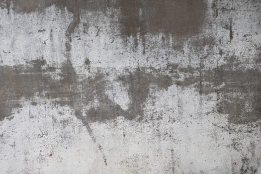 A detailed close-up of a weathered gray surface featuring abstract patterns, rough textures, and visible signs of aging and wear.