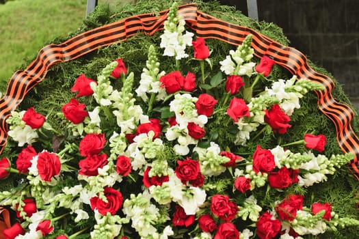 Basket with red rose and lily flowers Saint George ribbon