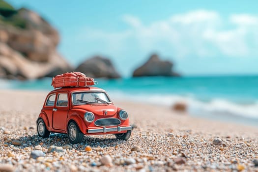 A charming vintage red toy car with luggage sits on a sandy beach, inviting thoughts of summer adventures and playful journeys along the turquoise ocean.