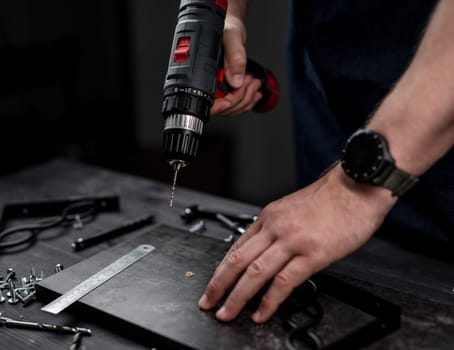 Man Holds Screwdriver In Hands Close-Up