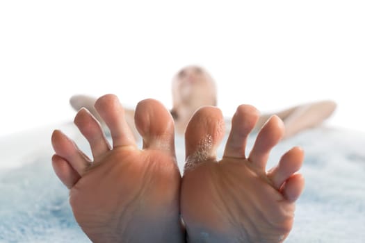 Girl in bath her feet and toes in close up view