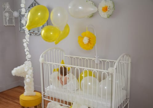 Little girl in a white dress celebrating first birthday