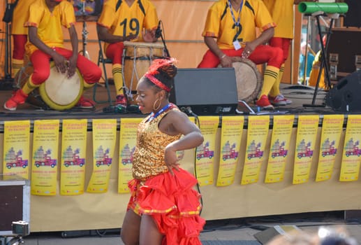 LE MANS, FRANCE - APRIL 22, 2017: Festival Evropa jazz Musicians playing drums and dancers dance Caribbean dance in costumes