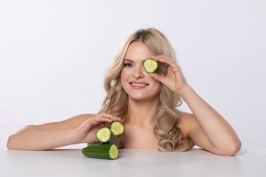 A woman enjoys a spa treatment with refreshing cucumbers, enhancing relaxation and rejuvenating her skin