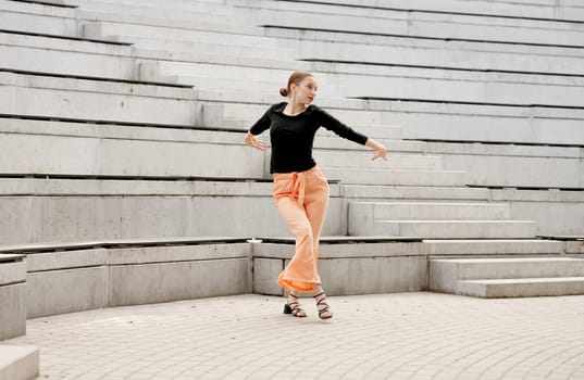 Sweet Girl Dances In Sandals At Amphitheater In Summer