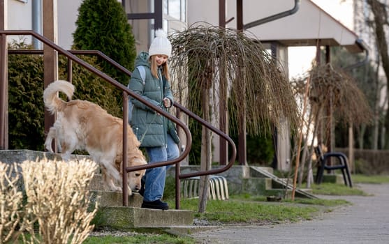 Girl With Golden Retriever Leaves House In Spring, Dog In City
